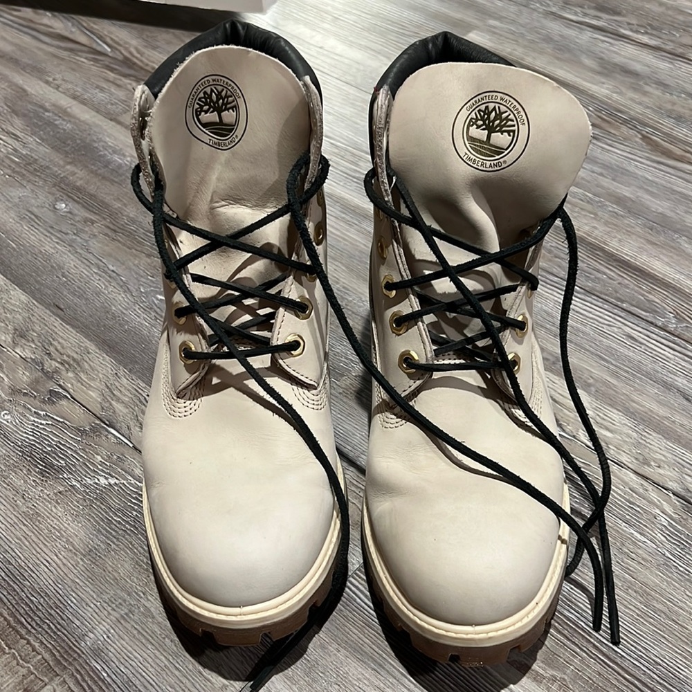 Timberland Boots size 9.5. Cream/white color with black laces and gold accents.